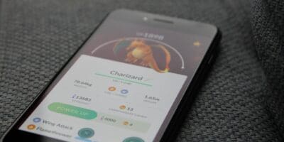 turned on iphone displaying pokemon go charizard application